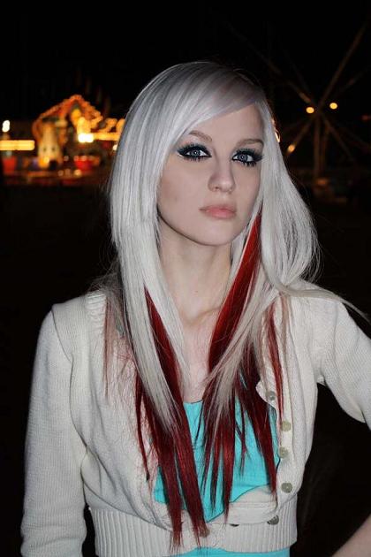 Platinum blonde hair with red streaks.