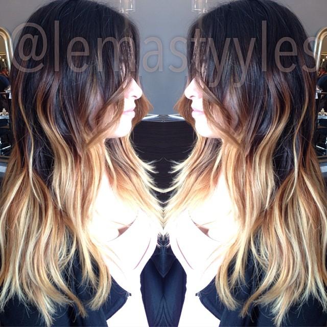 Kept her dark roots, and lightened up her ends while balayaging some brunette to blend