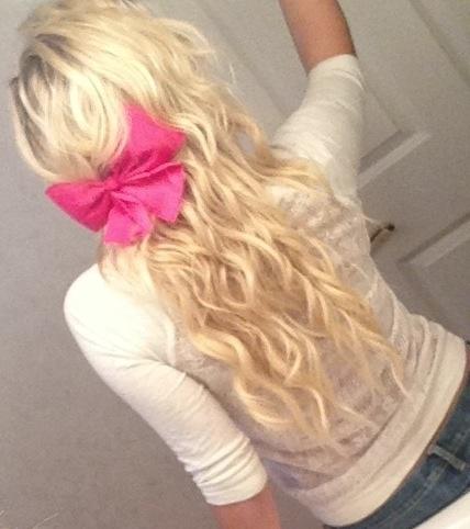 Blonde curly hair with pink bow