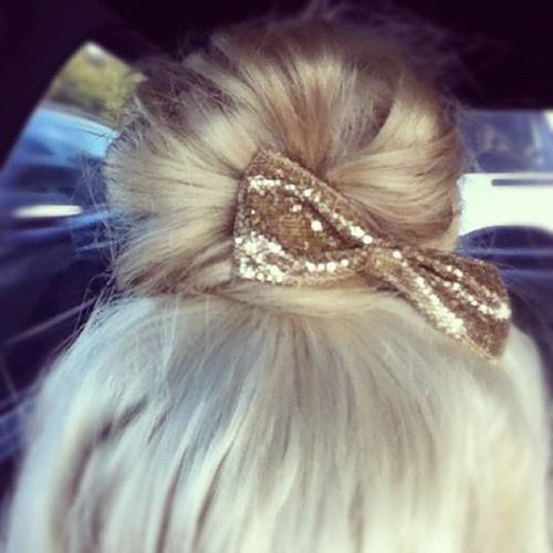 Messy bun with gold glittery bow
