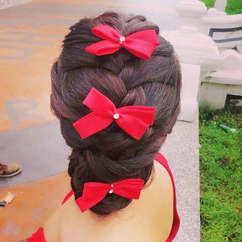 braided updo with red bows