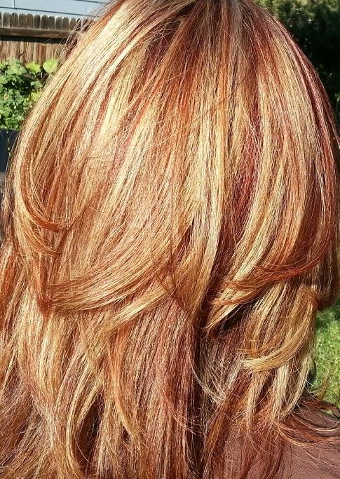 red or auburn hair with subtle, natural blonde highlights